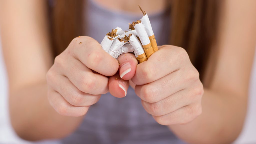 woman destroying cigarettes