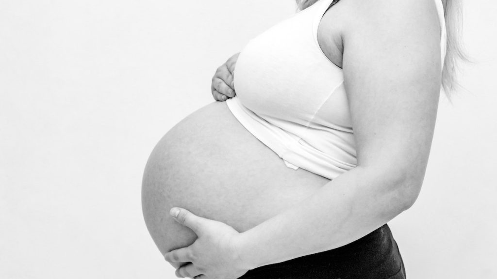 pregnant woman holding her belly