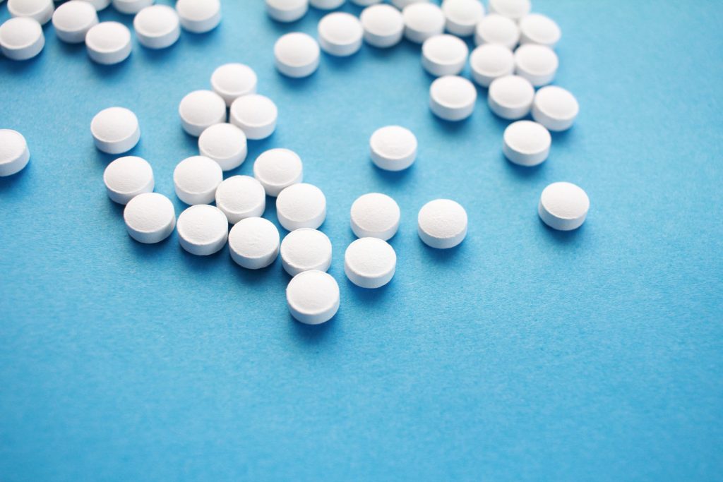 white pills on blue table