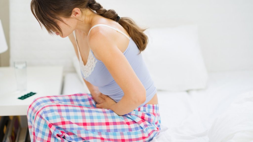 A woman experiencing abdominal pain