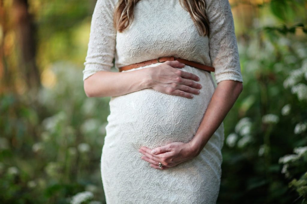 pregnant woman holding her tummy