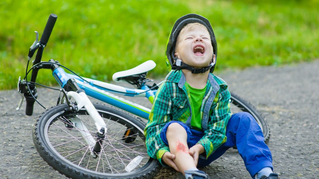 little boy crying after a bike accident