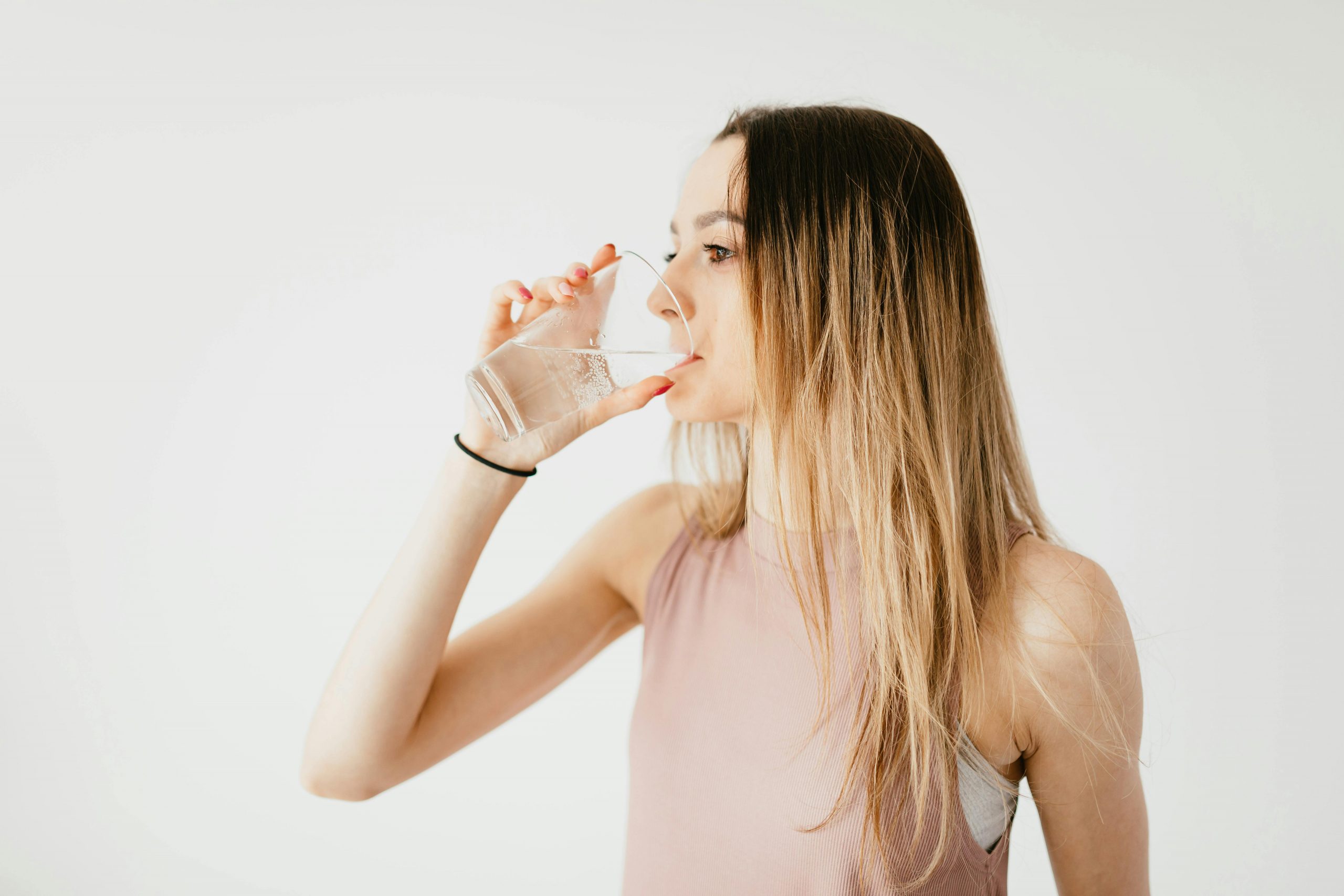 woman drinking water from a glass
